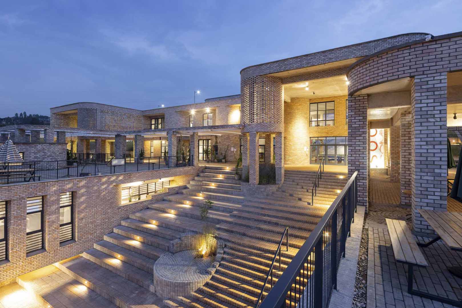 Exterior view of the African Leadership University with the lights on at night