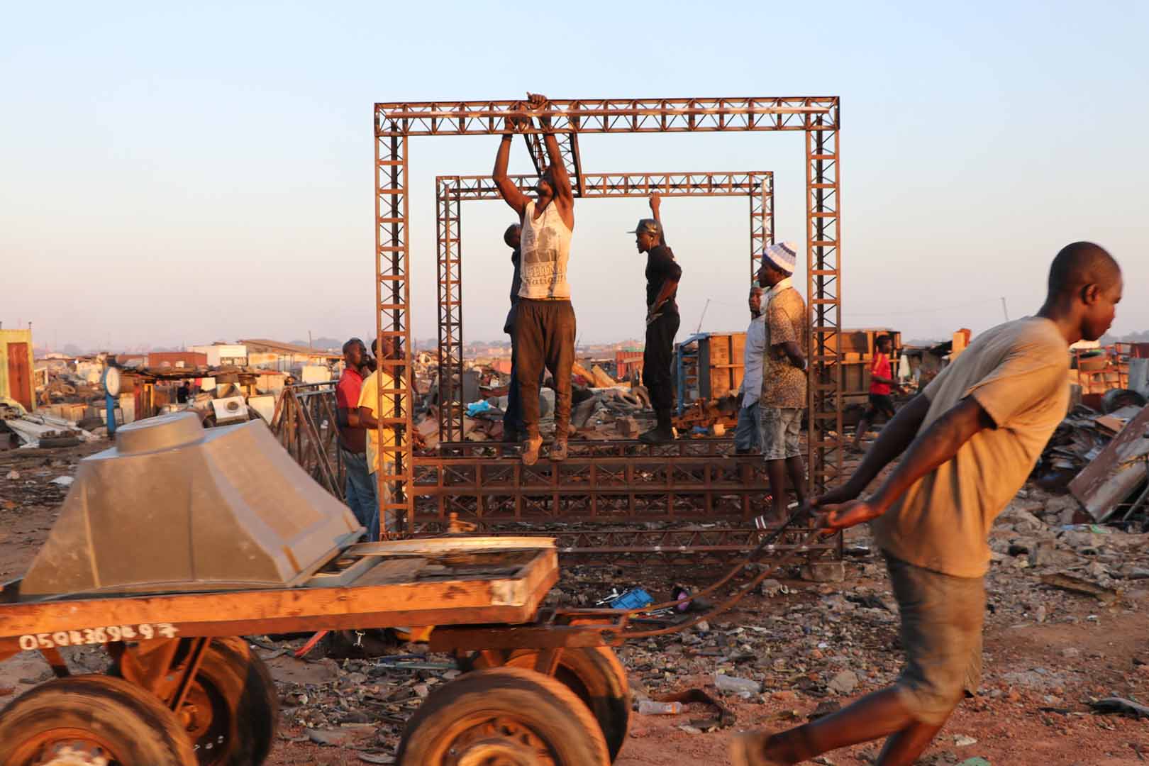 Group of people constructing a building in a rural area