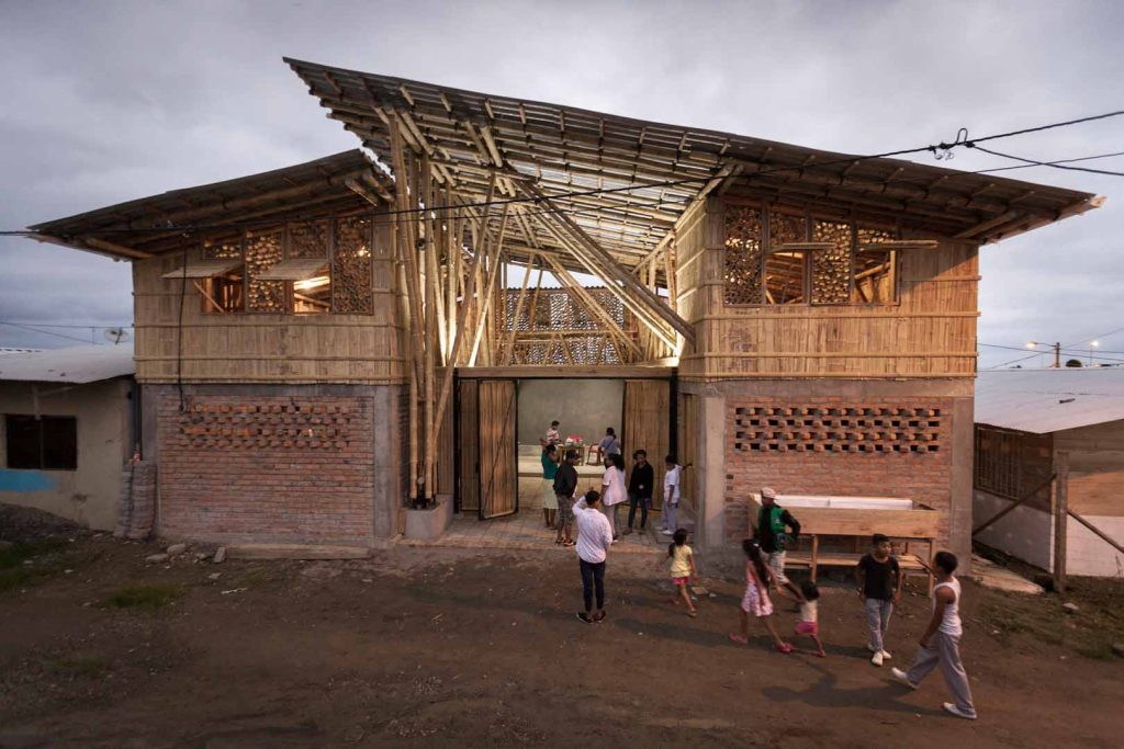 People walking into a large open building