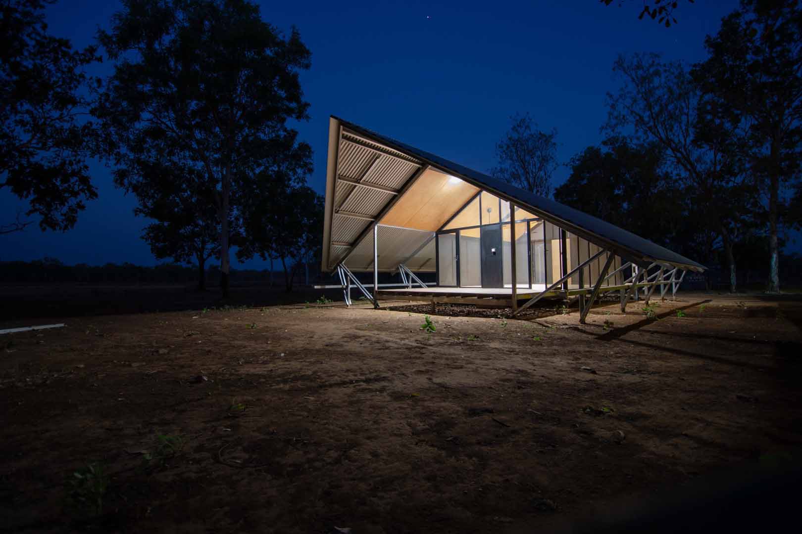 Building with light on at dusk