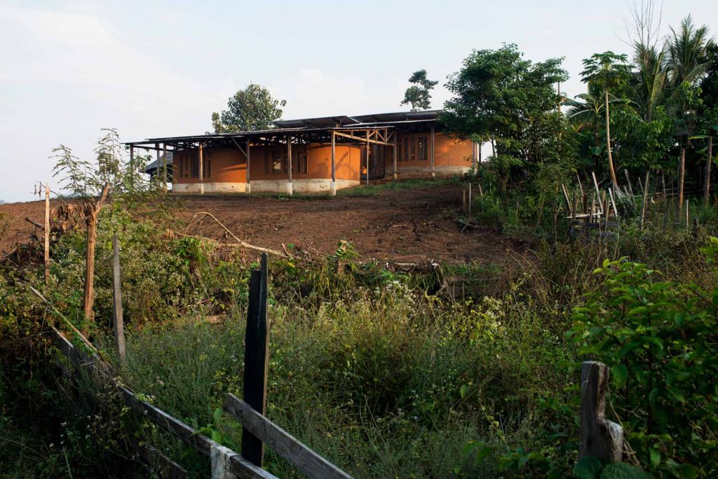 Building on a hill with trees behind