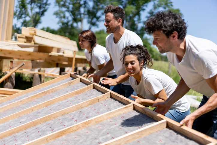 Latin american volunteers working hard at a charity construction project - Charity and relief concepts